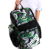 Green and black patterned backpack with 'arena' branding held by a person.